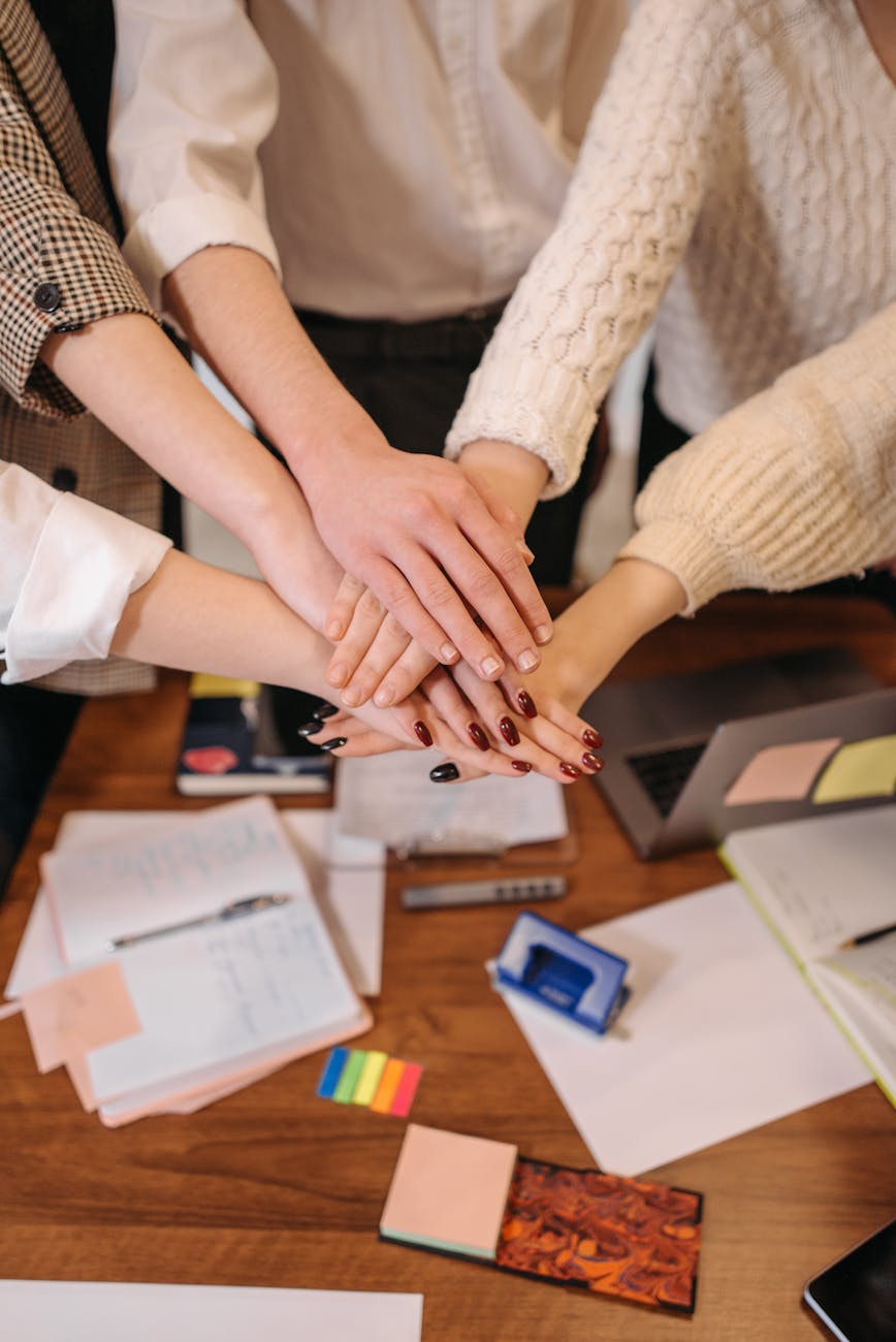 business people stacking hands in support